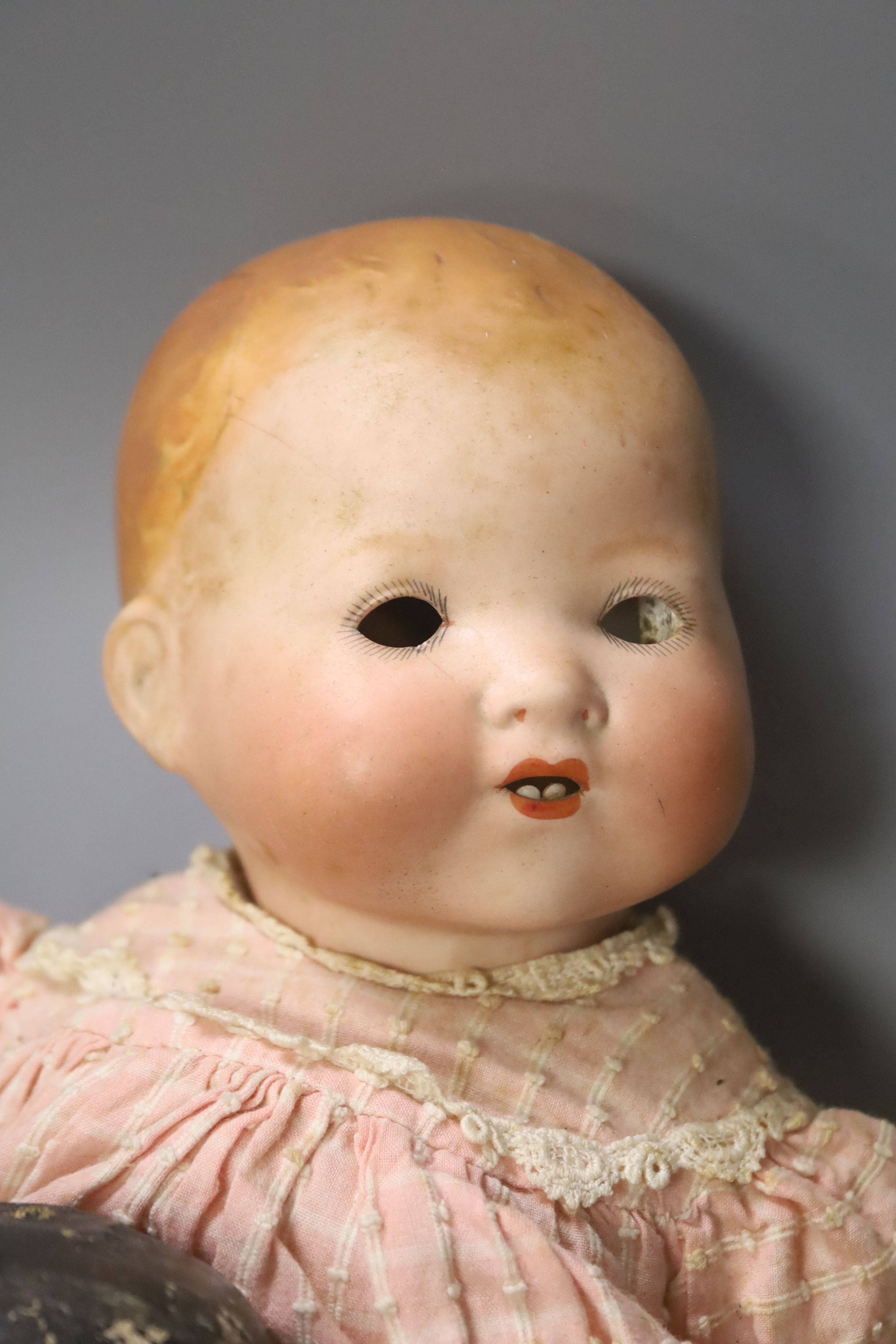 A collection of four dolls including an AM bisque head doll, height 38cm